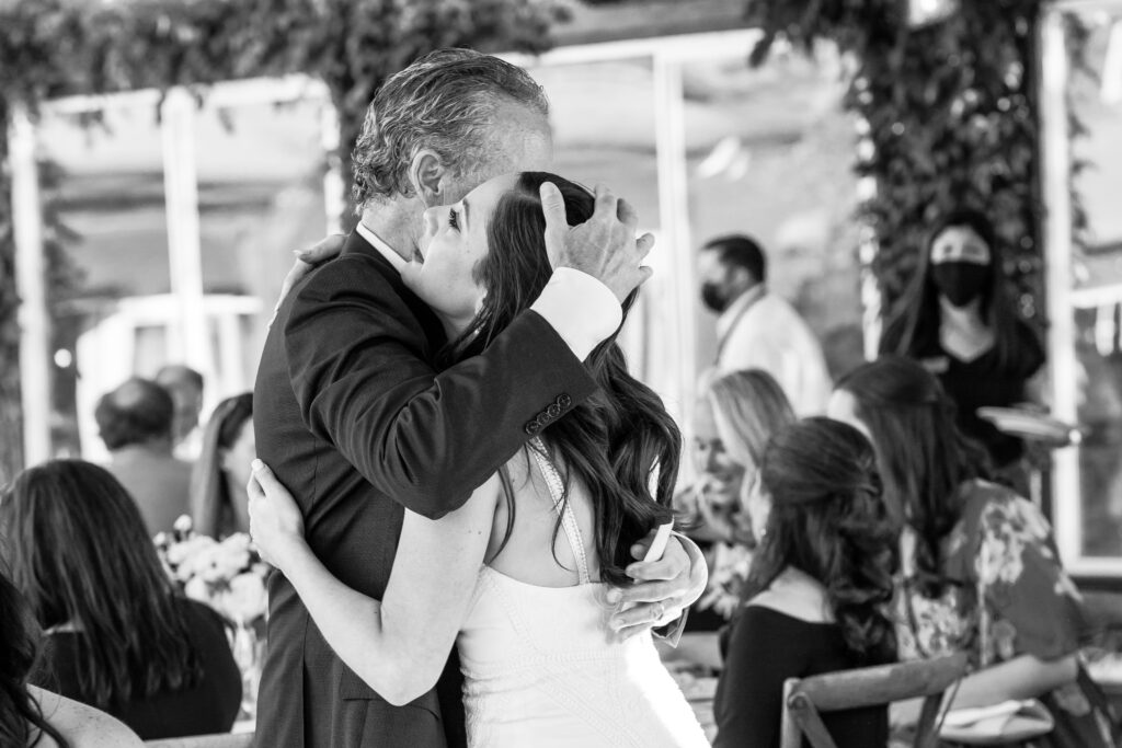 Bride and her father embrace after a heartfelt father of the bride speech