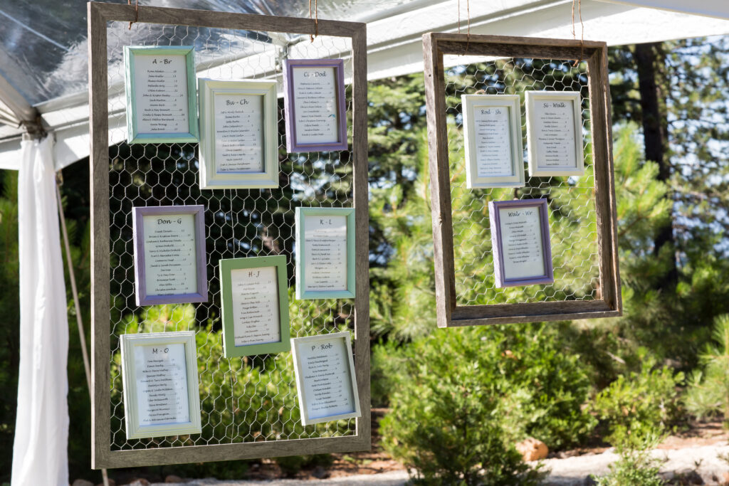 Find your seat and table assignment from colored frames hung on custom framed hanging chicken wire