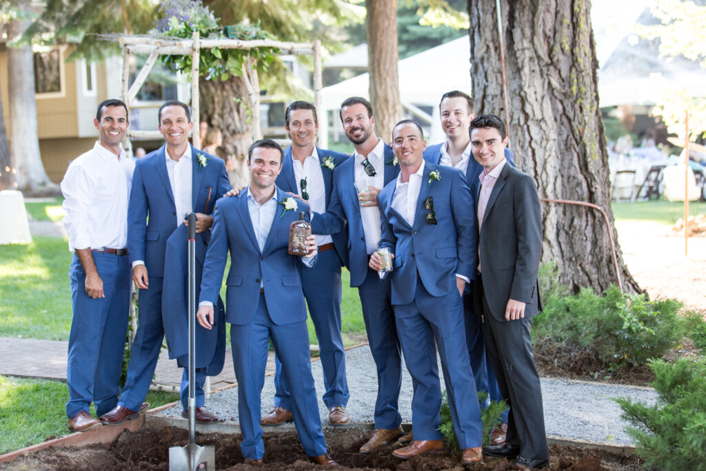 Happy groomsmen with an unearthed bottle of bourbon to enjoy