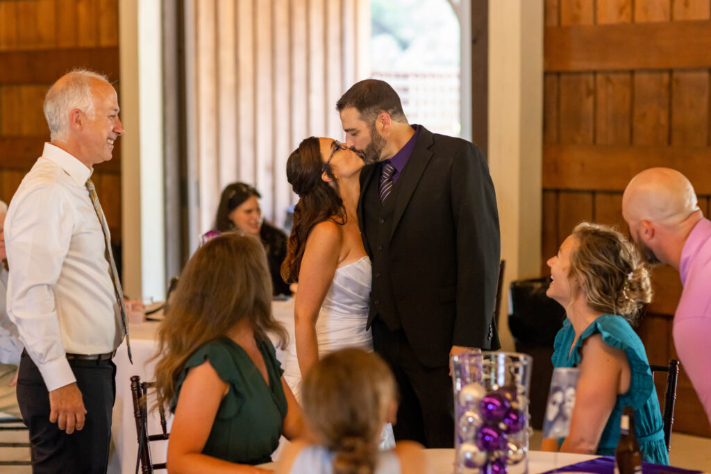 bride and groom kissing at their wedding reception in the barn at Eden at Gracefield