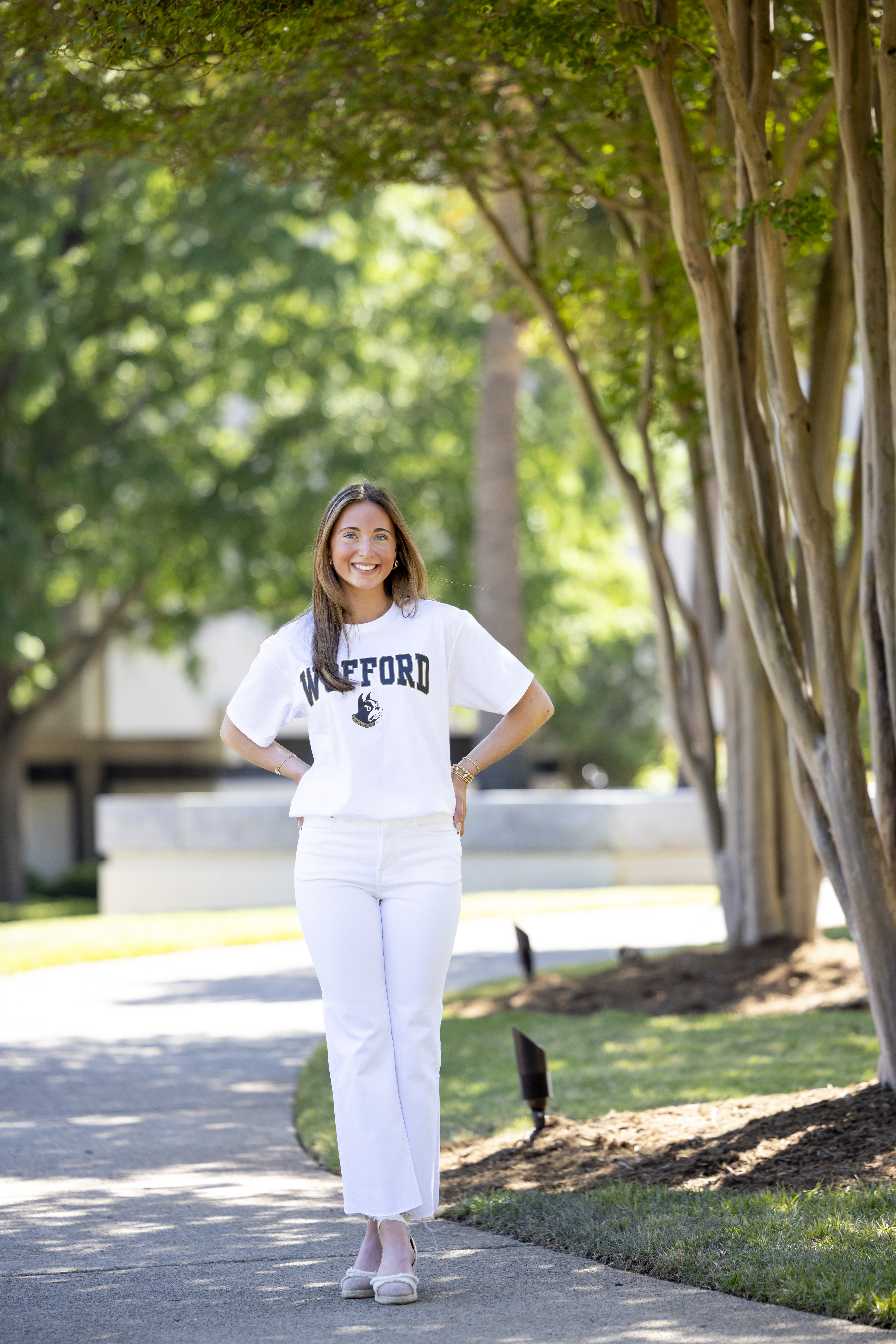Full-body senior portrait of a high school graduate at the University of South Carolina Horseshoe wearing a Wofford shirt