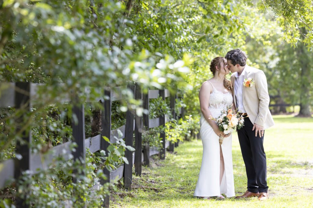 Bride and groom kiss in the back garden of the Twelve Oak Estate in Lexington South Carolina